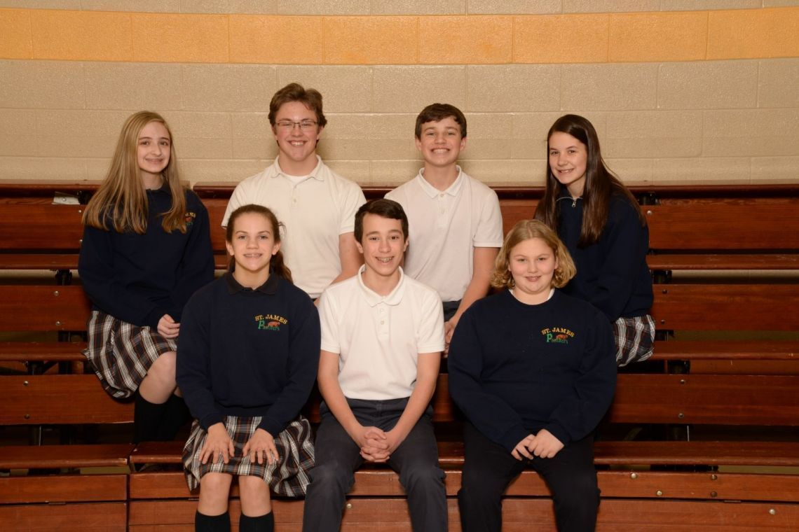 A group of young people are posing for a picture