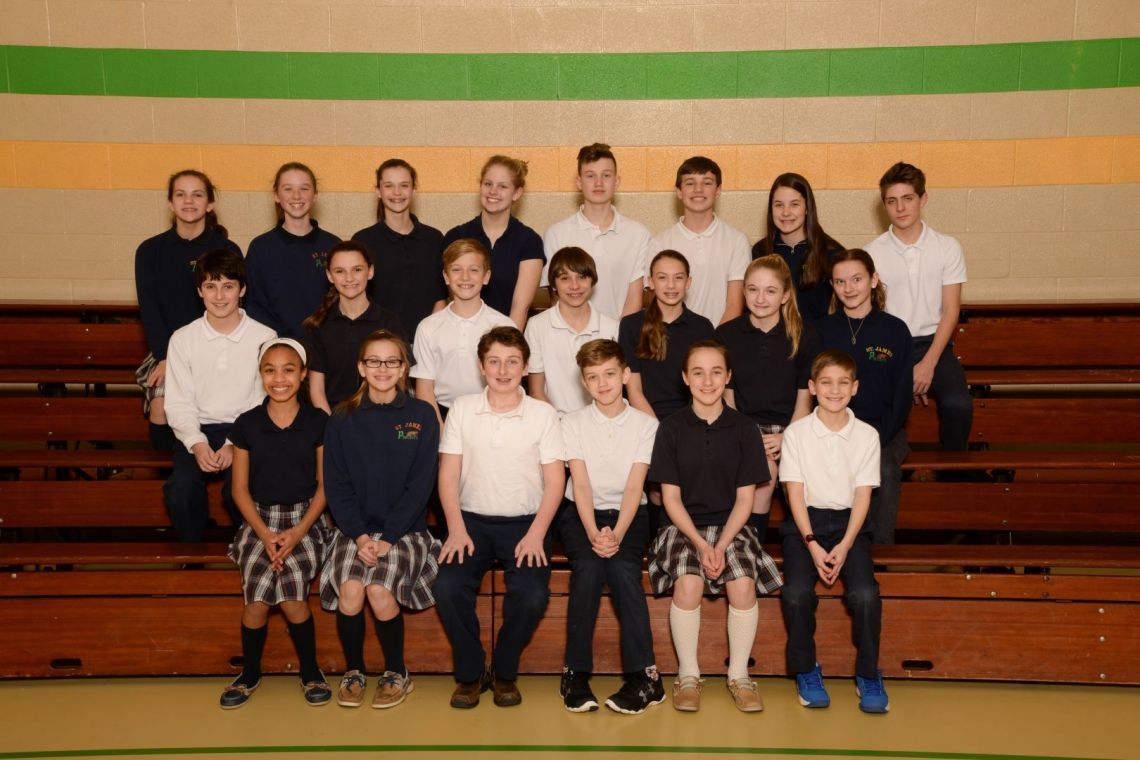 A group of children pose for a picture in a gym