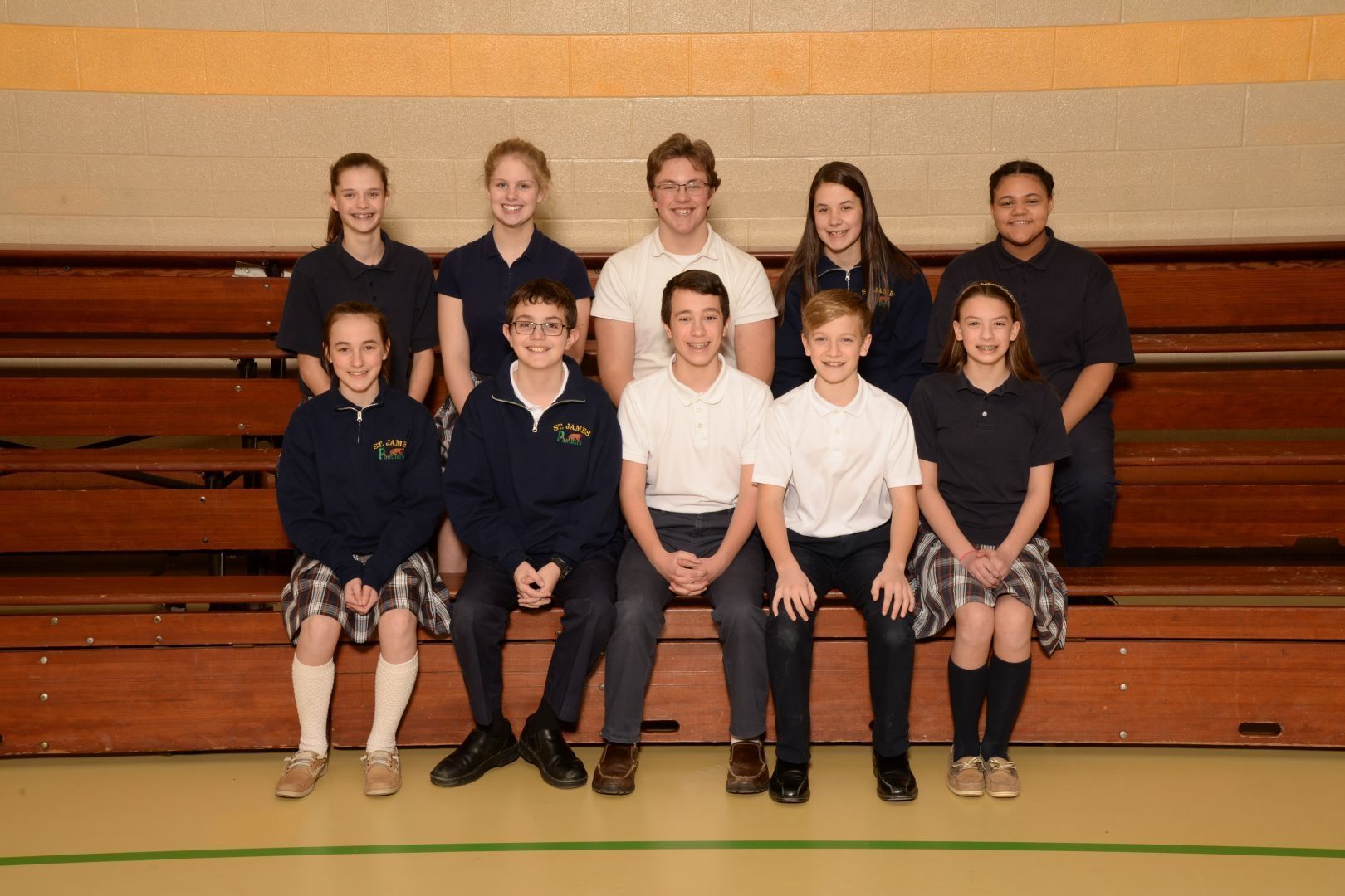 A group of children are posing for a picture in a gym