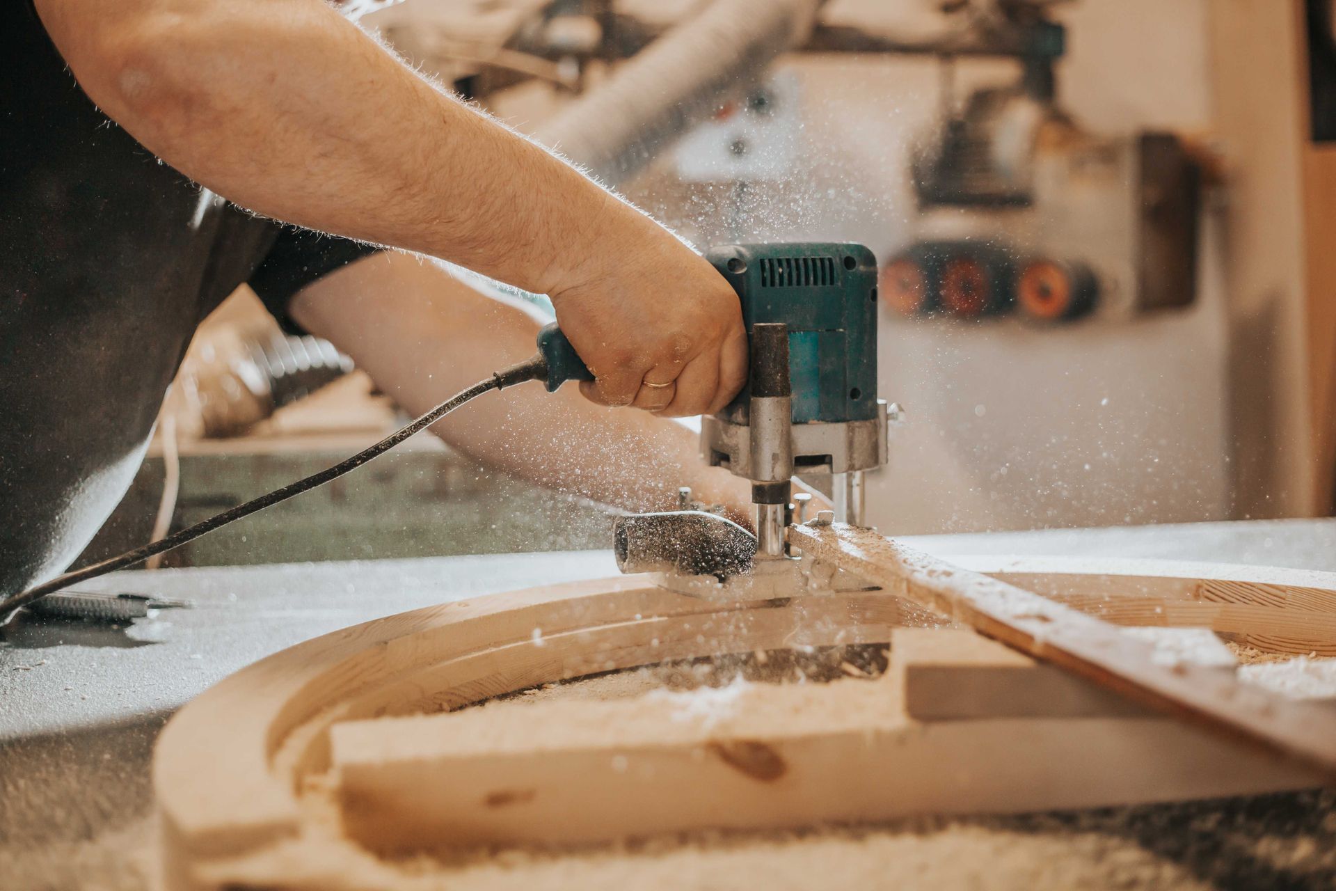 A man using a power tool to build cabinets
