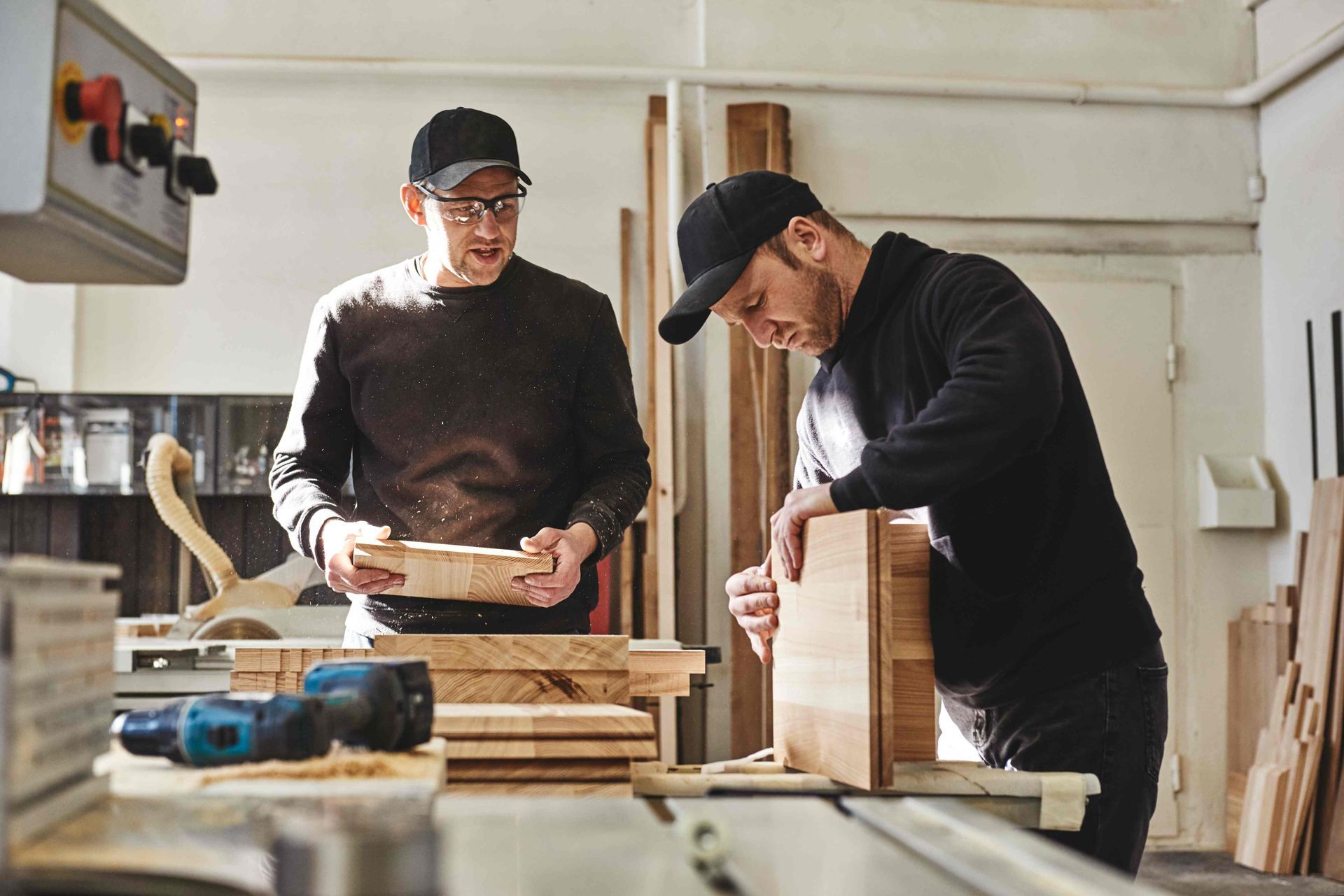 Two dudes building cabinets together