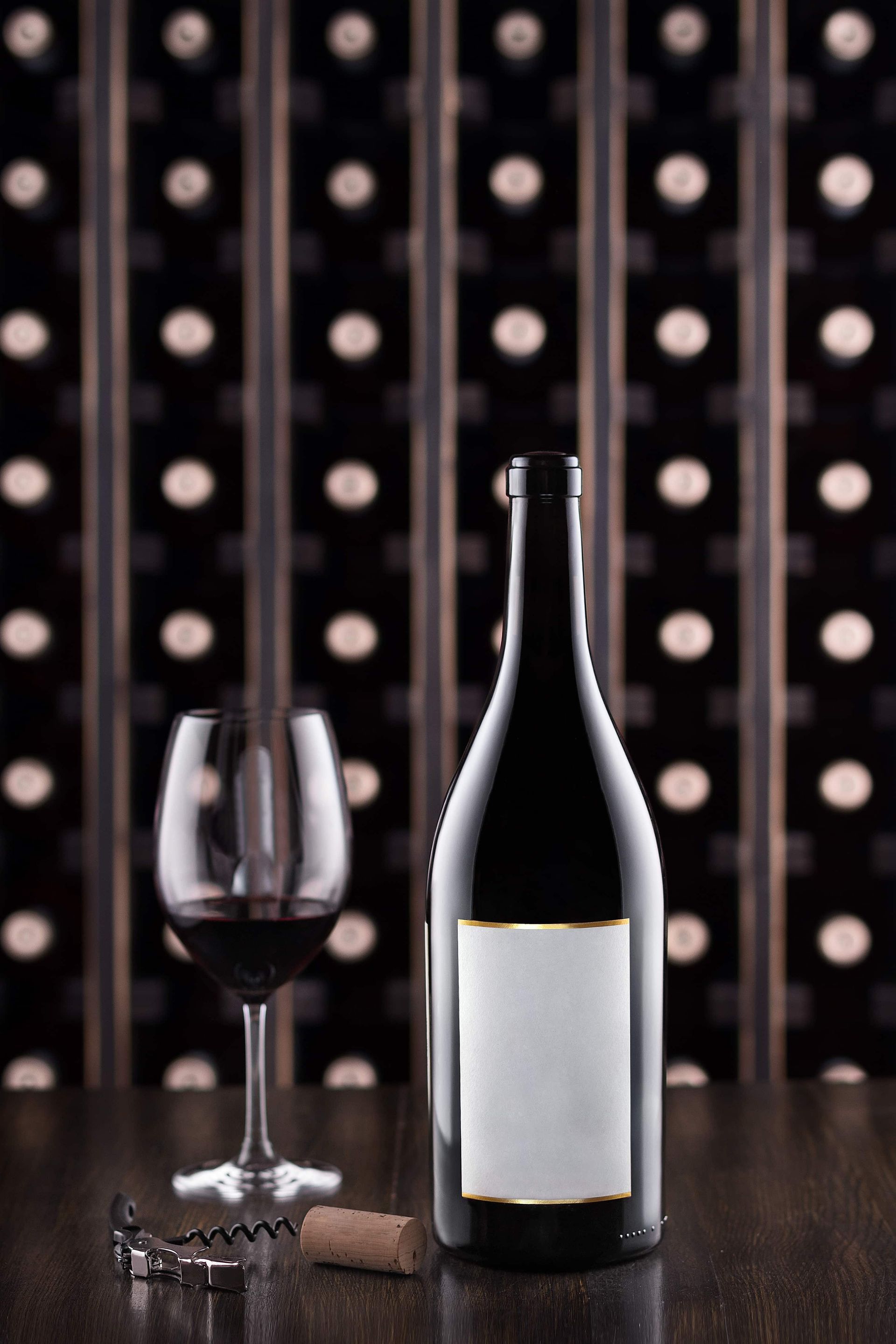 Wine bottle and glass in front of wine cabinet