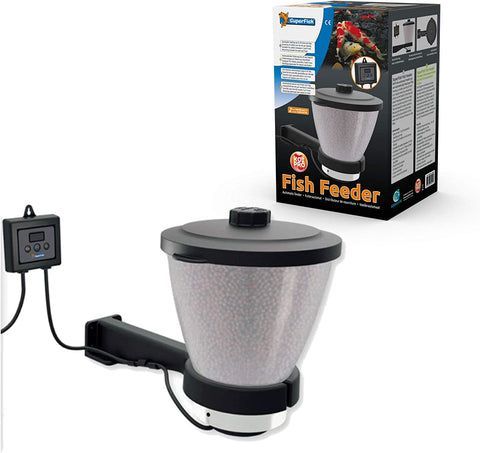 A fish feeder is sitting next to a box.