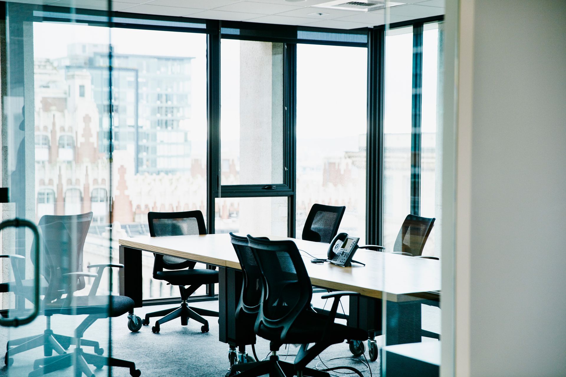 A conference room with a long table and chairs.