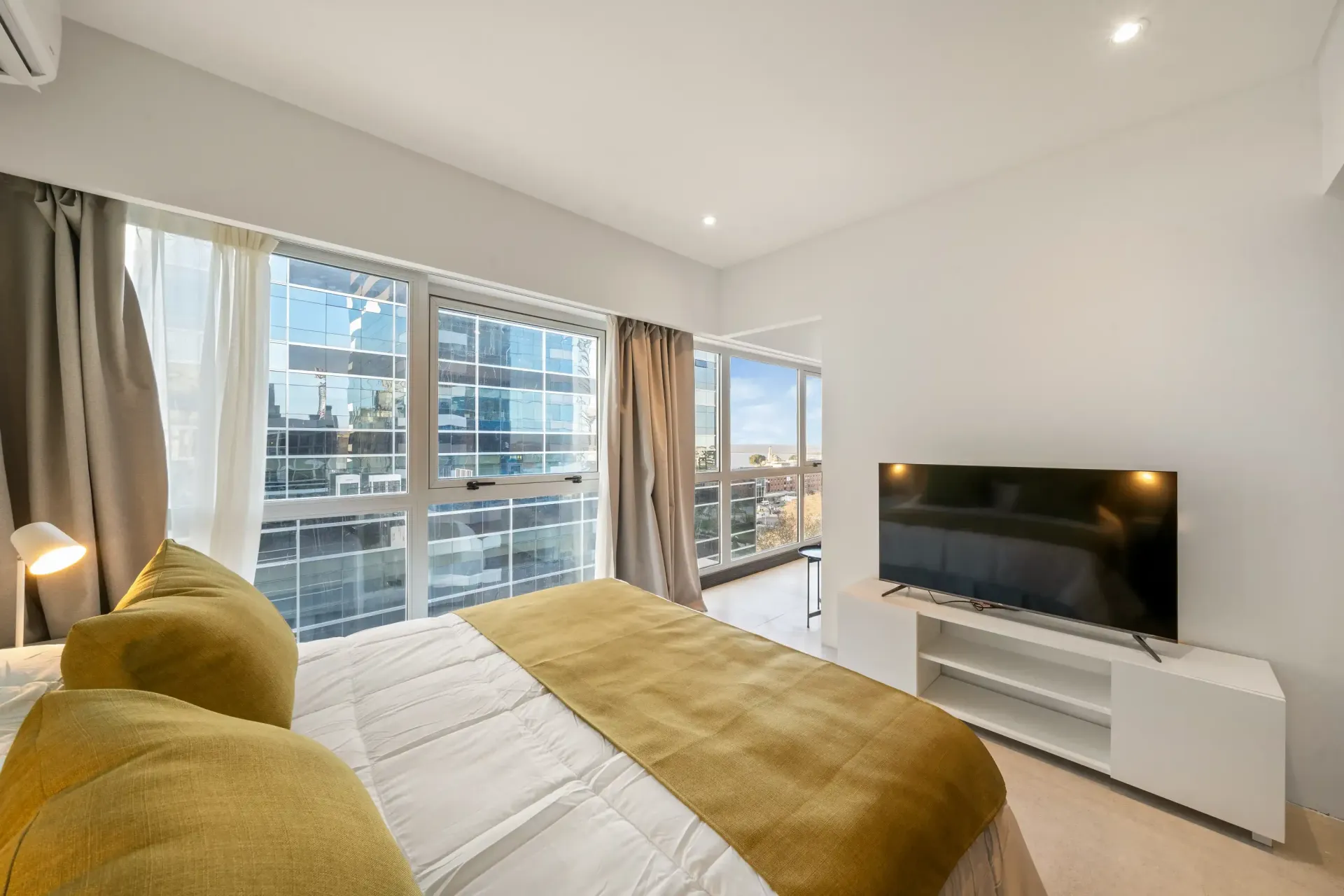 Un dormitorio con una cama grande y un televisor de pantalla plana.