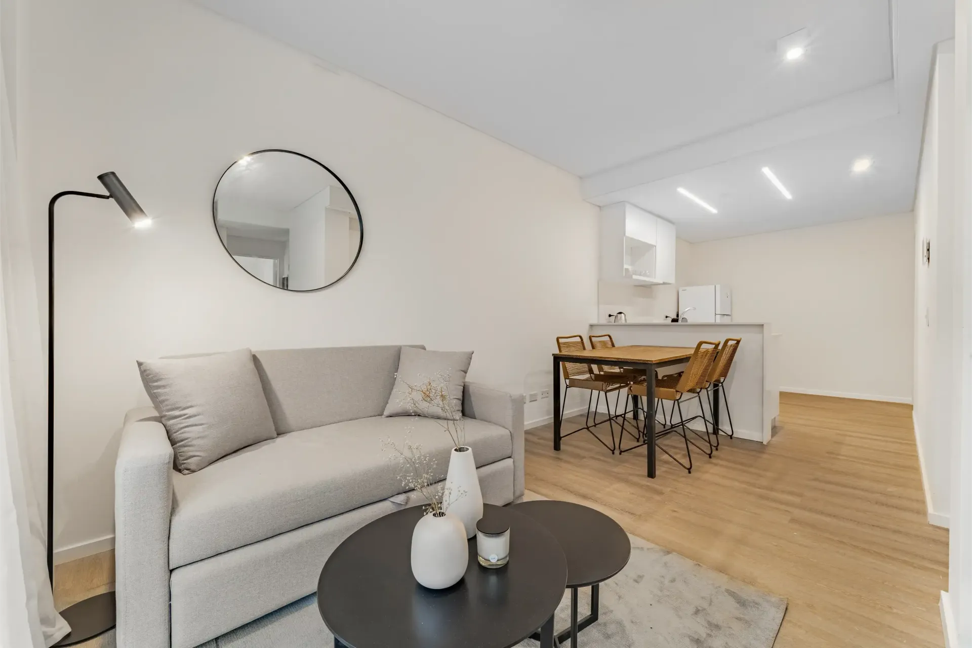 Una sala de estar con un sofá y dos mesas de café.