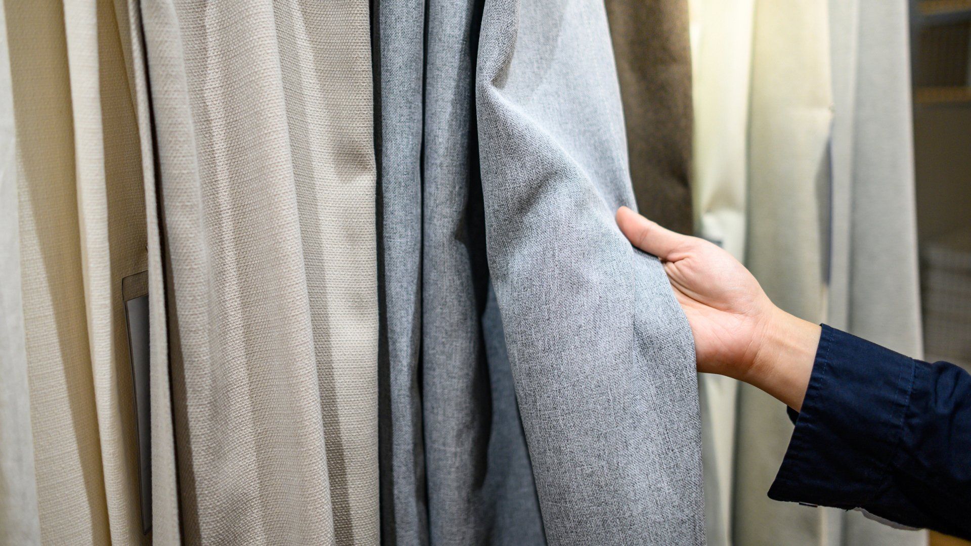Person Choosing a Curtain — Mornington, VIC — Boutique Interiors and Floors