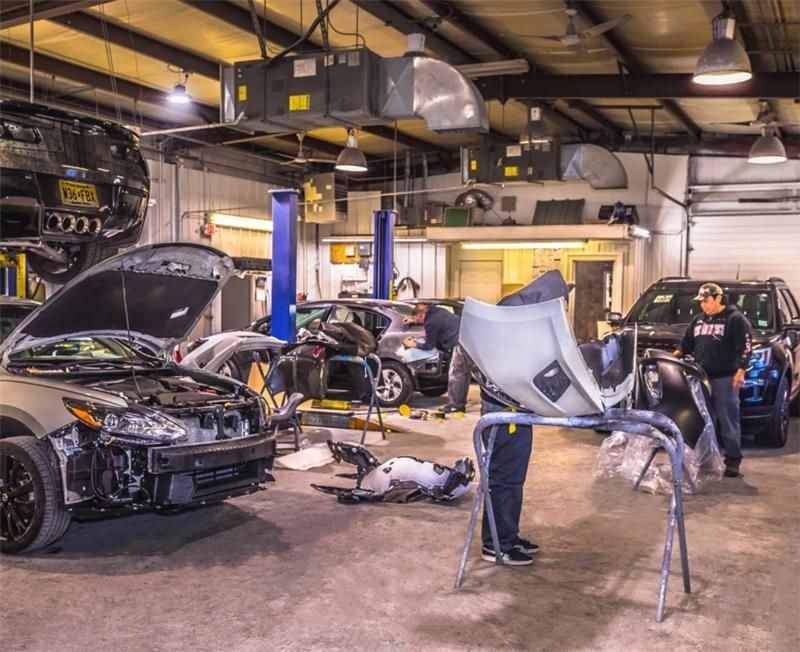 A man is working on a car in a garage.