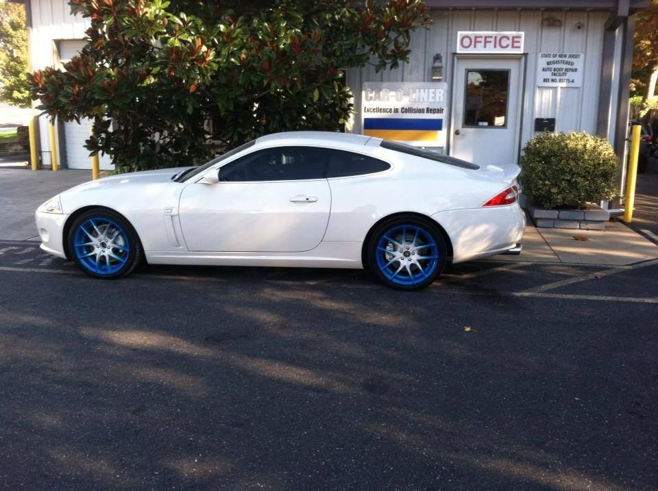 A white sports car is parked in front of an office