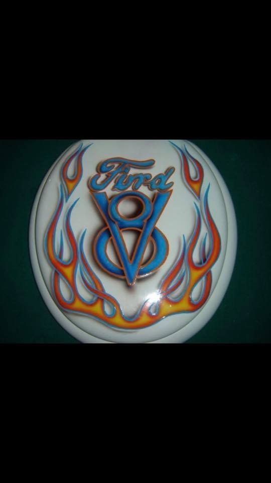 A white circle with a ford logo and flames on it