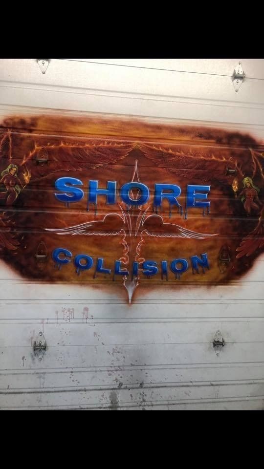 A sign on a garage door that says shore collision
