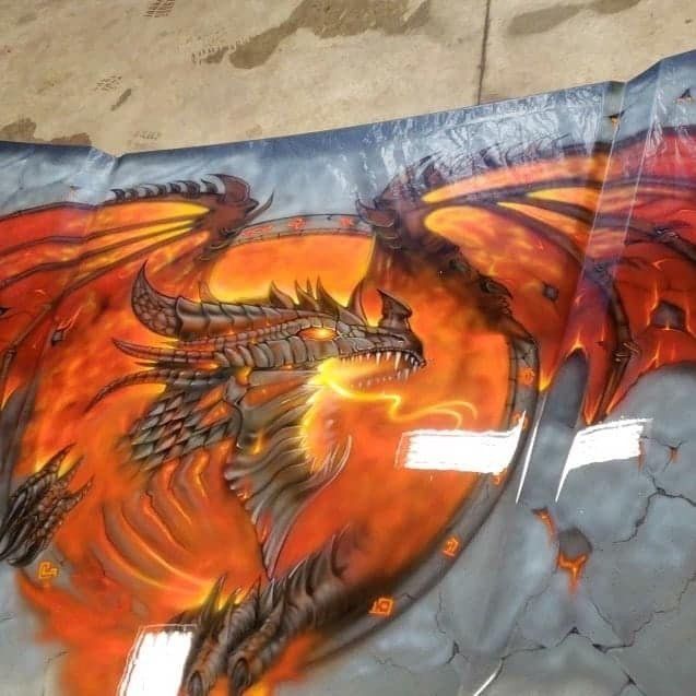 A painting of a dragon with flames coming out of its mouth