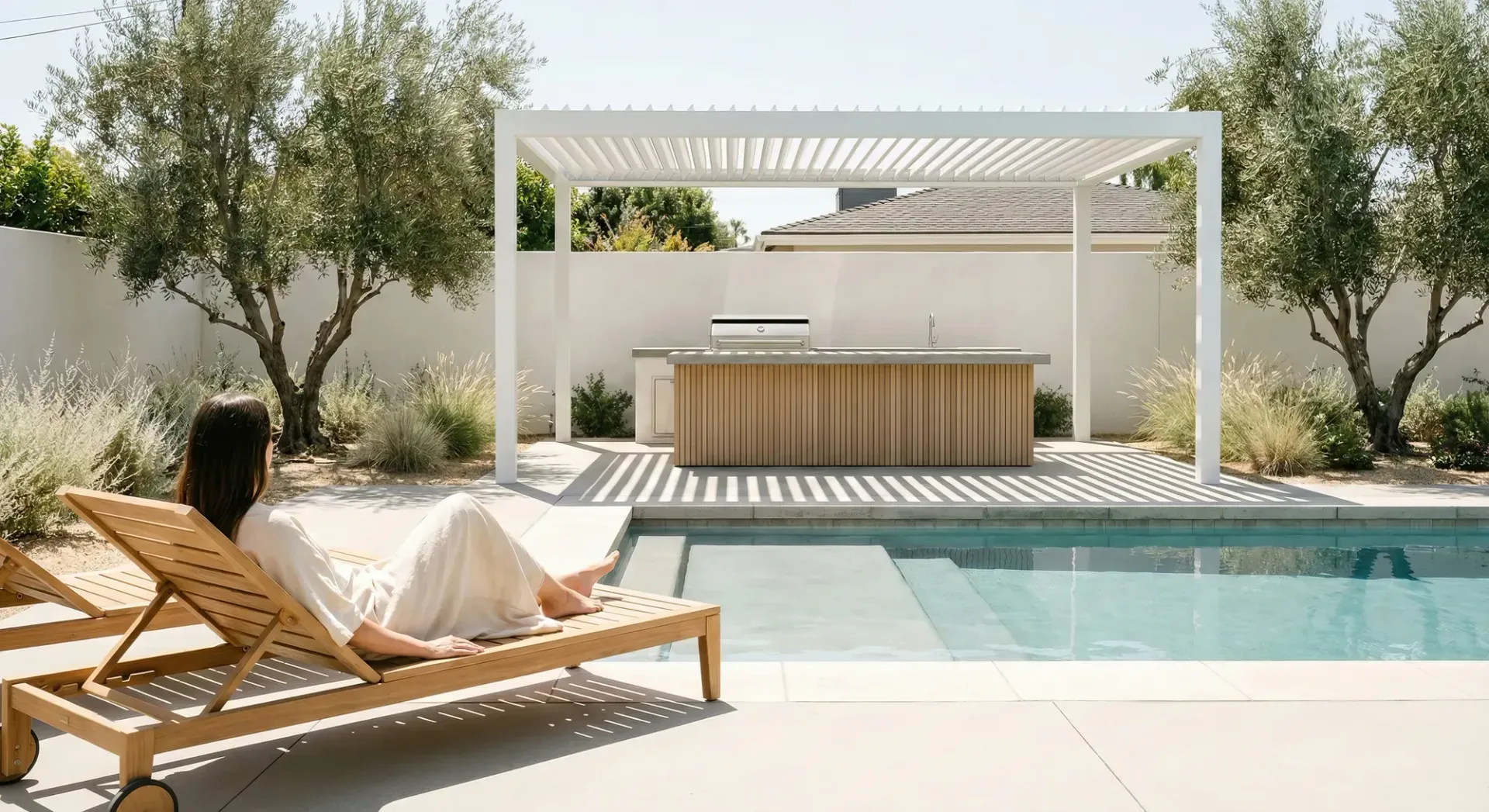 custom designed and built outdoor living space in irvine, ca. Outdoor kitchen with a custom pergola with lighting next to a custom fire pit and relaxing seating. Design and construction work done by Costa Outdoor Living.