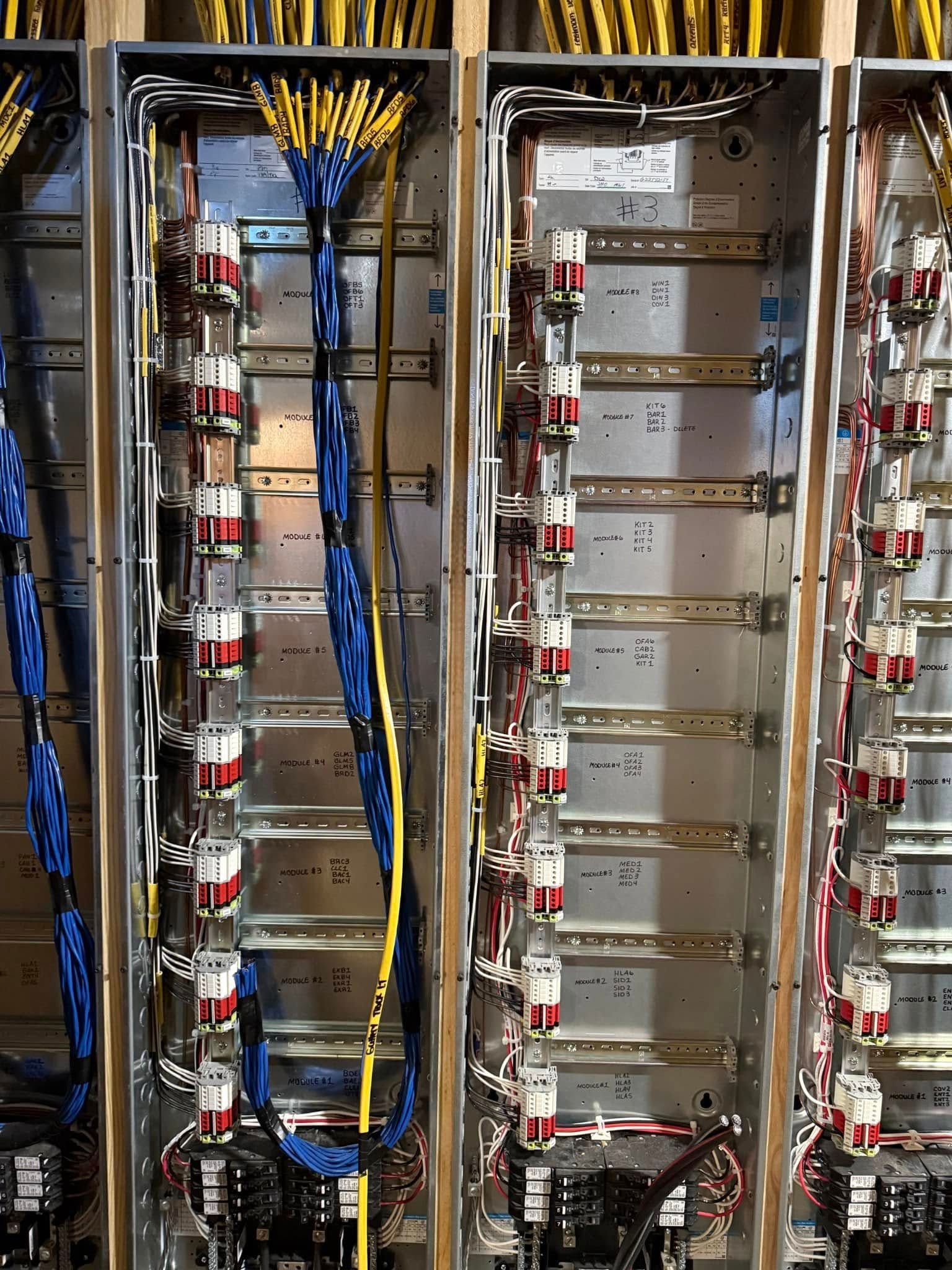Electrician testing a circuit breaker panel with a multimeter in a home