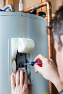 Technician fixing water heater Technician fixing water heater