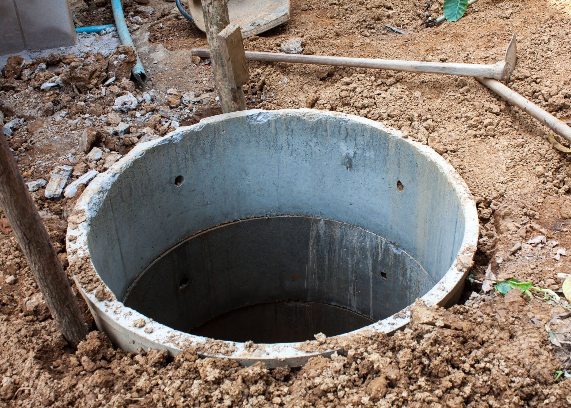 Sewer — Springville, UT — Blue Plumbing and Drain Cleaning A concrete well is being built in the dirt.