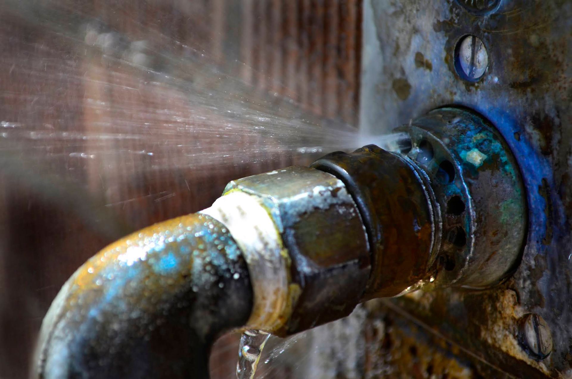 A close up of a faucet with water coming out of it.