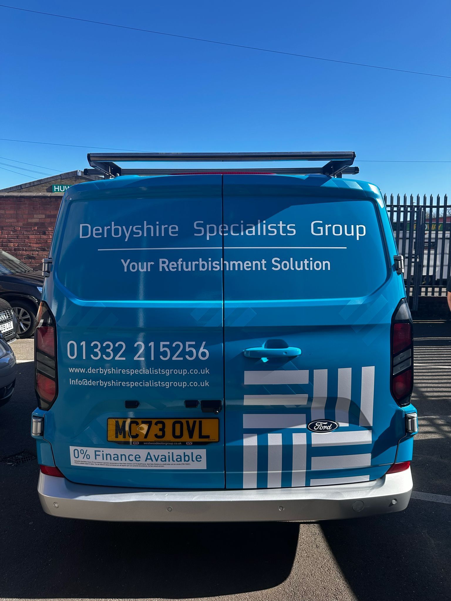 The back of a Derbyshire Specialists Group van showing the company name, phone number and finance offer