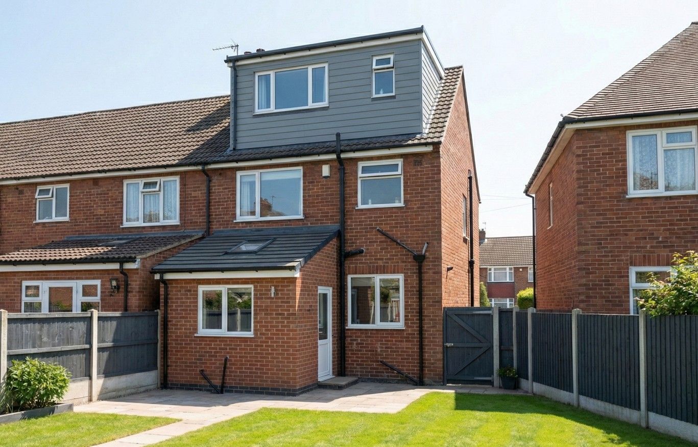 Full-width rear dormer clad in grey on a red-brick end-terraced house