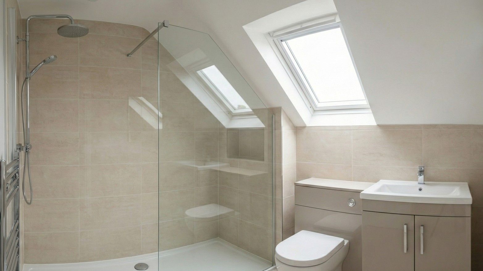 A stylish and modern en-suite bathroom within the dormer conversion, featuring a walk-in shower and a Velux window.