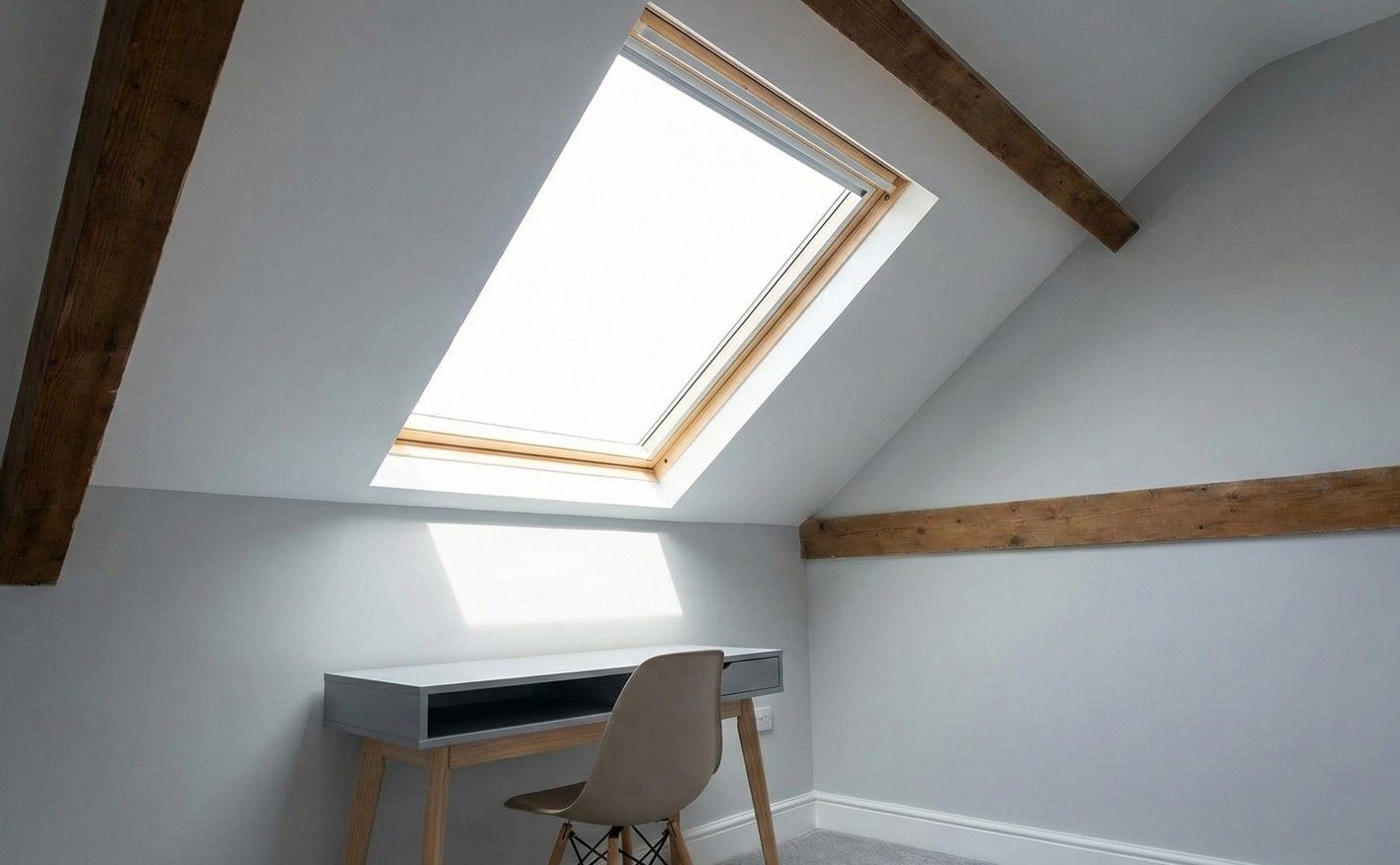 Completed loft conversion, transformed into a bright study with a large Velux window and exposed beams.
