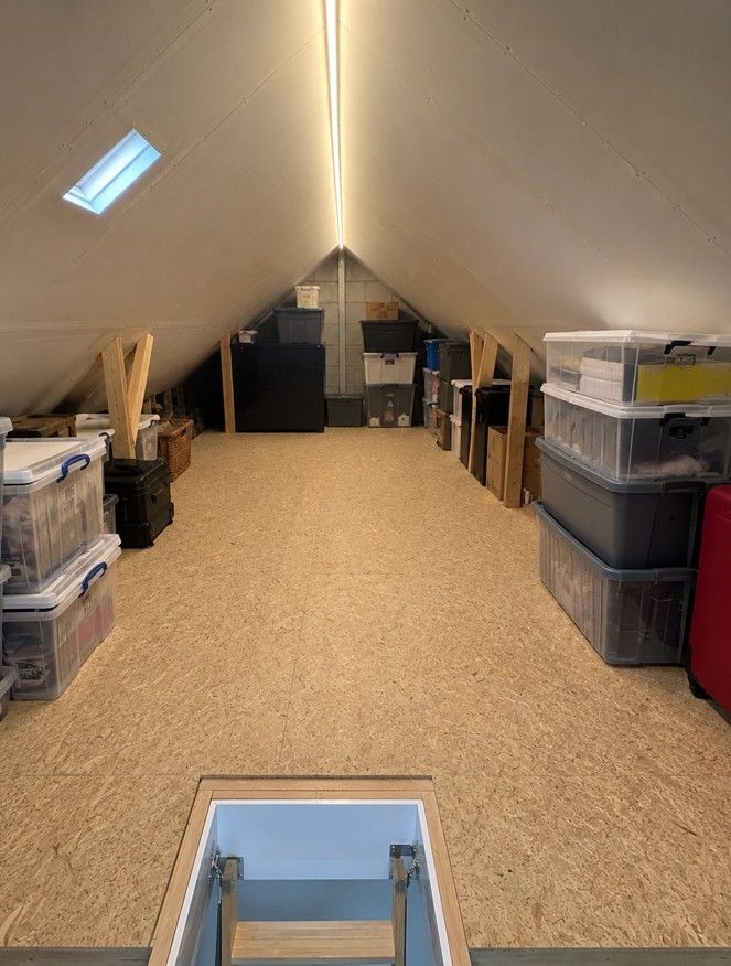 Boarded loft in Derbyshire home being used for organised storage after professional loft boarding installation