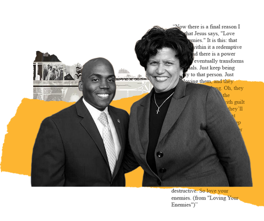 Two people smiling, posing together. Man in suit, woman in blazer, partially obscured by paper with text and yellow shapes.