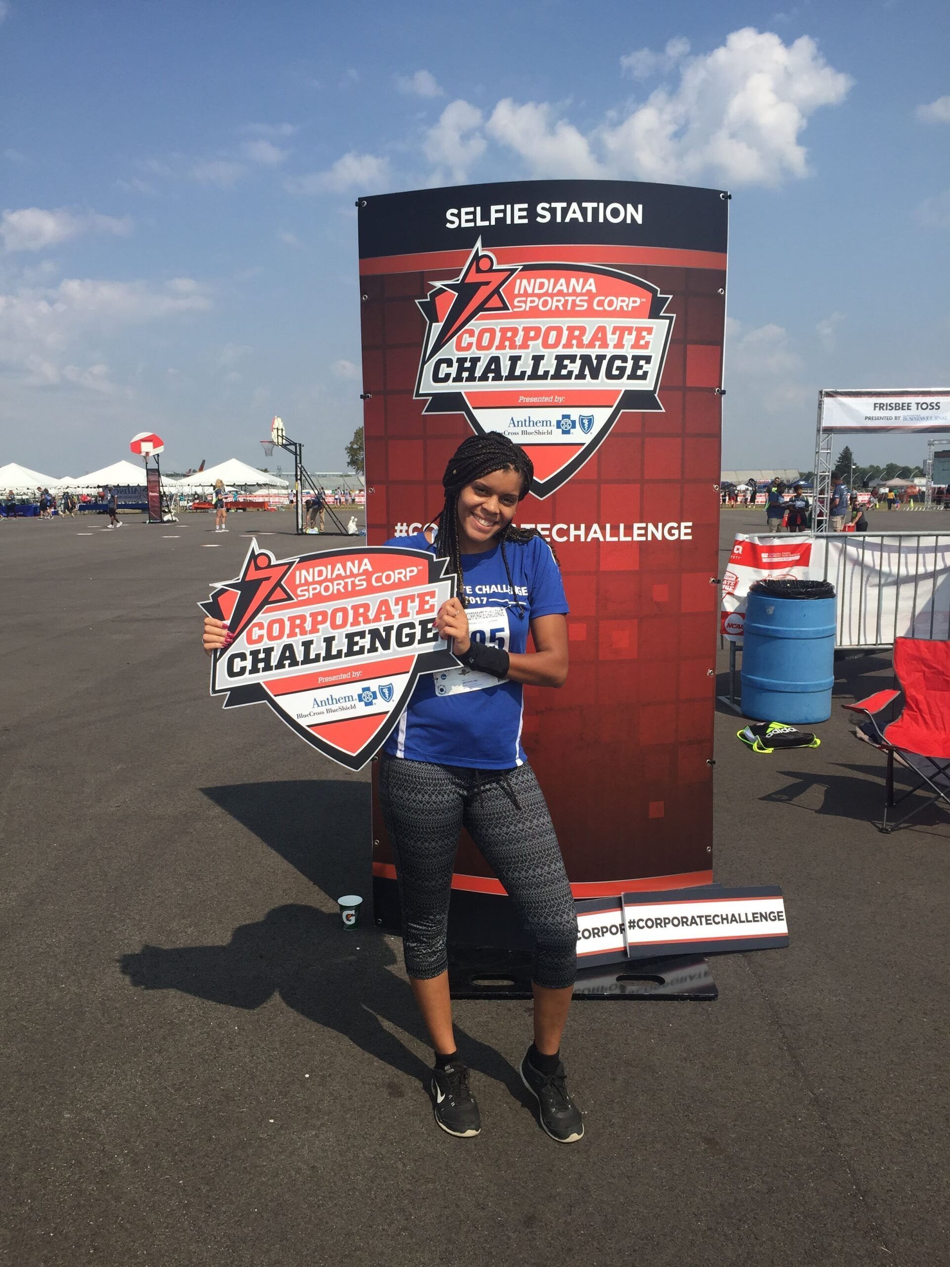 Brittaney Jenkins holding a sign at the Indiana Sports Corporate Challenge 