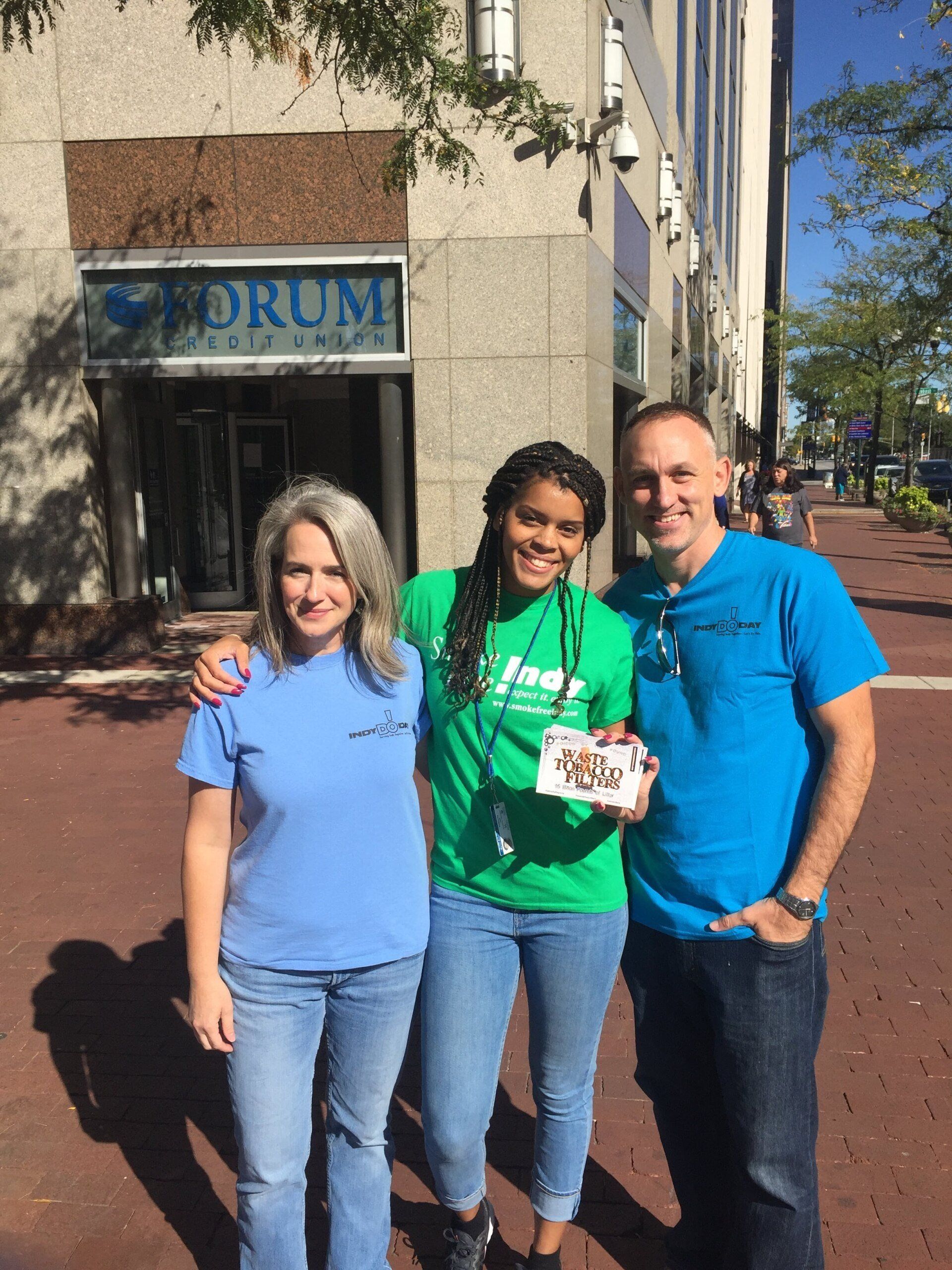 Brittaney Jenkins  and a woman and man smiling outside a building