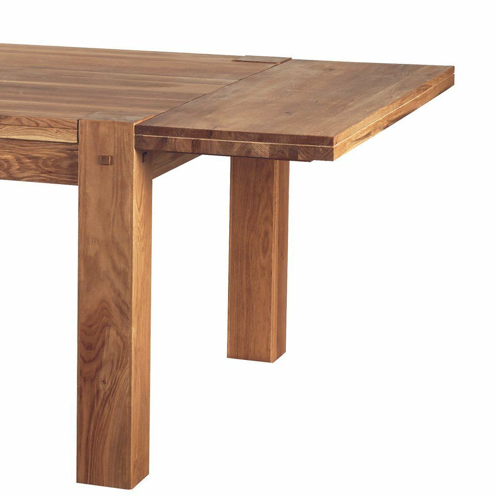 Table de salle à manger en bois avec rallonge et menuiserie apparente.