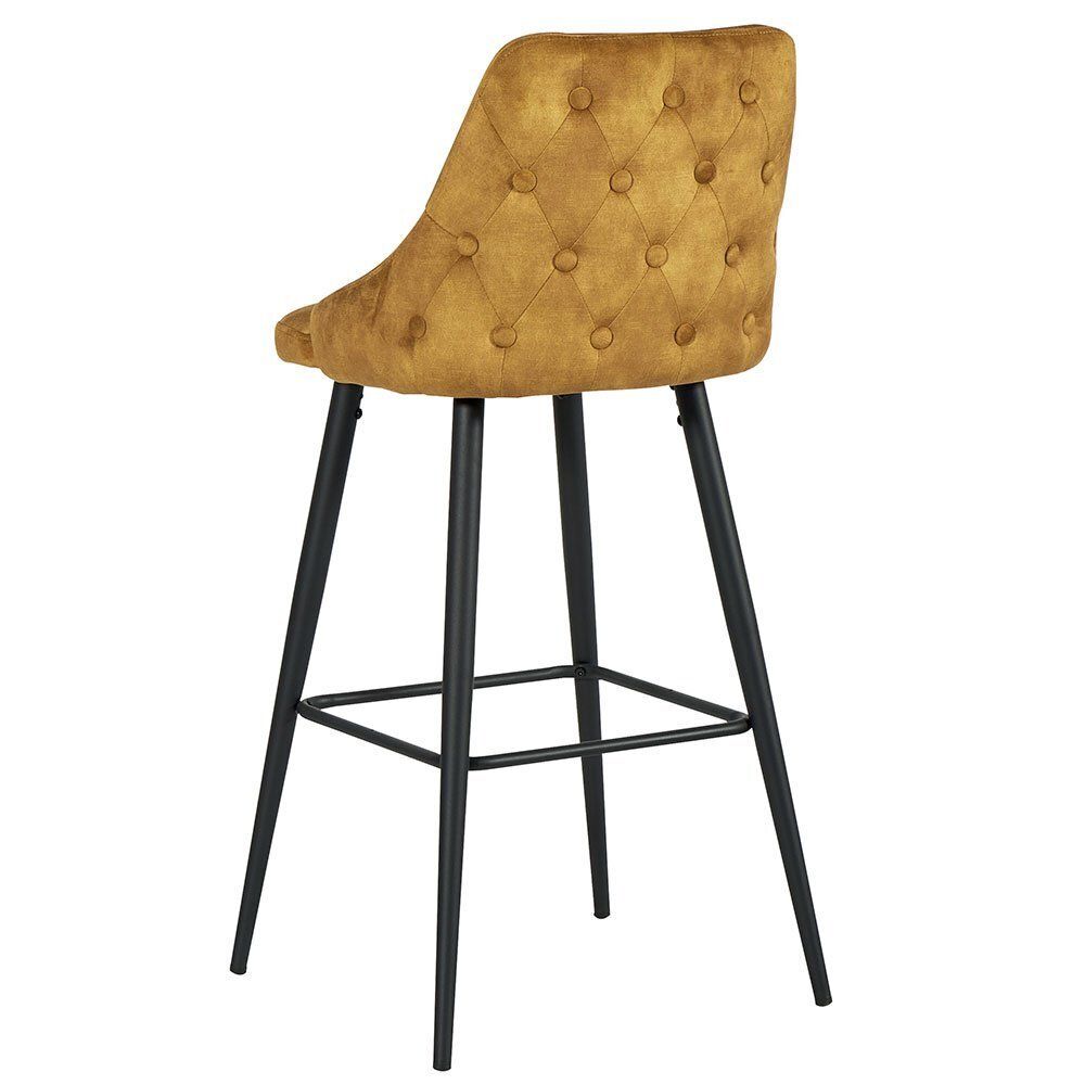 Tabouret de bar capitonné jaune moutarde avec pieds en métal noir.