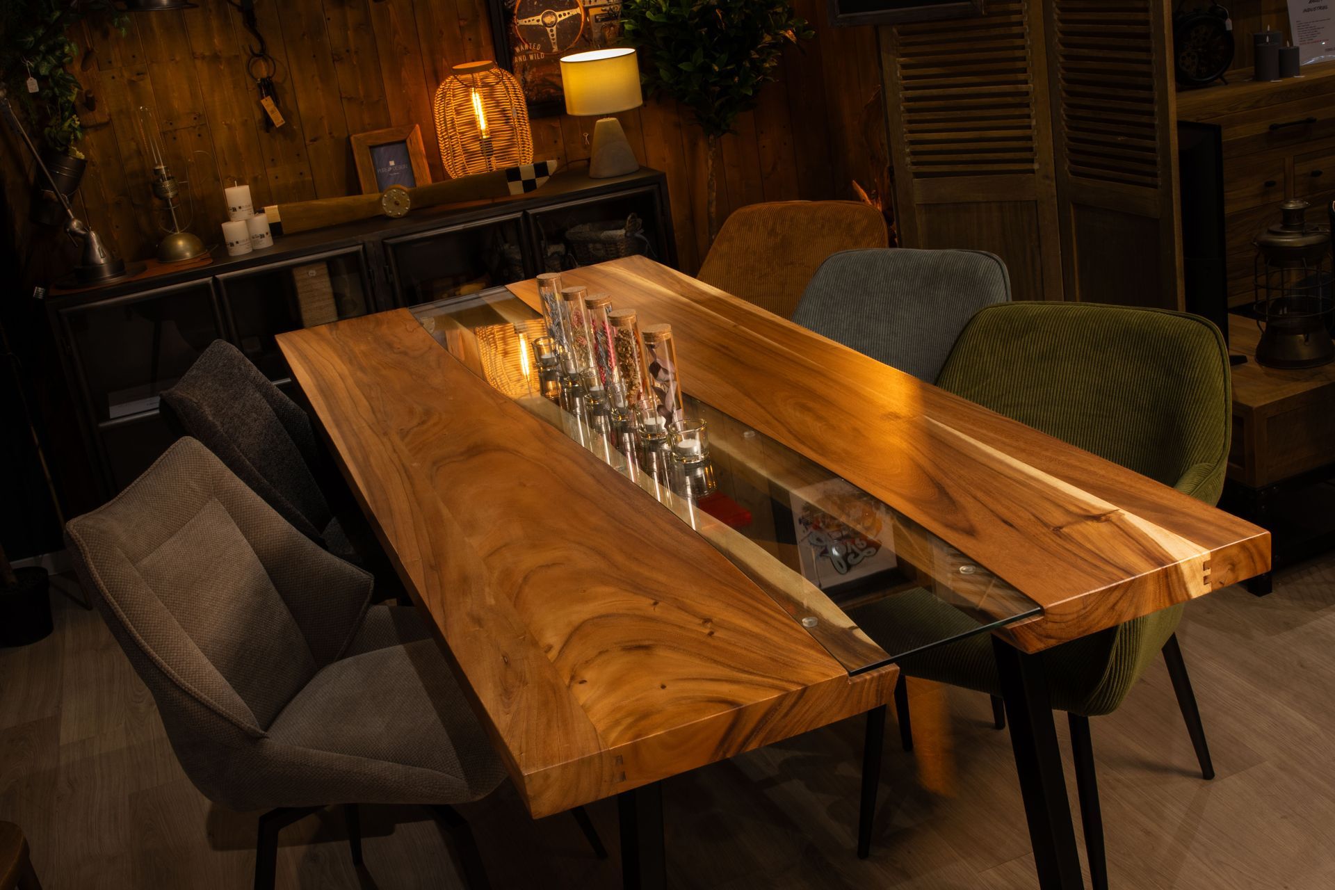 Table en bois incrustée de résine et munie de robinets à bière, entourée de chaises dans une ambiance de bar tamisée.