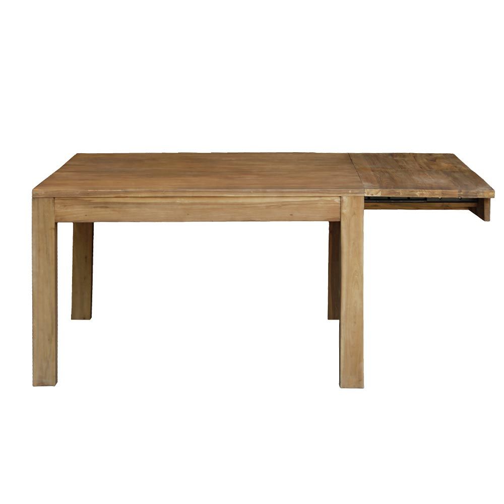 Salle à manger moderne avec table en bois, chaises noires et grandes fenêtres donnant sur une végétation tropicale luxuriante.