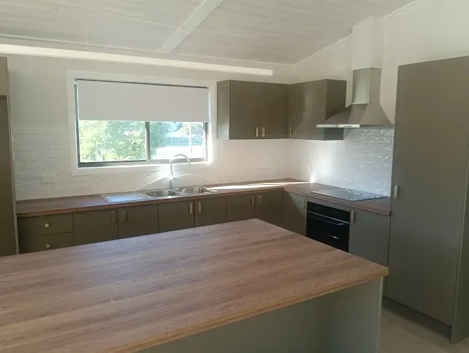 Licensed builder inspecting completed kitchen renovation