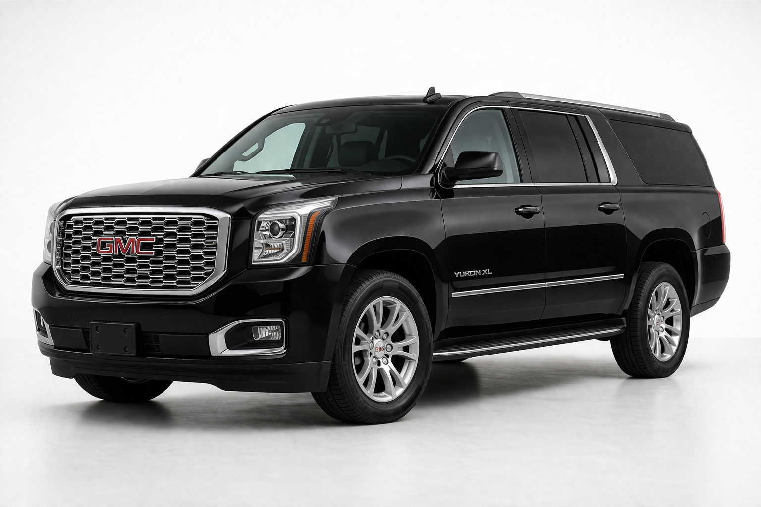 A black GMC Yukon XL SUV parked against a plain white background.