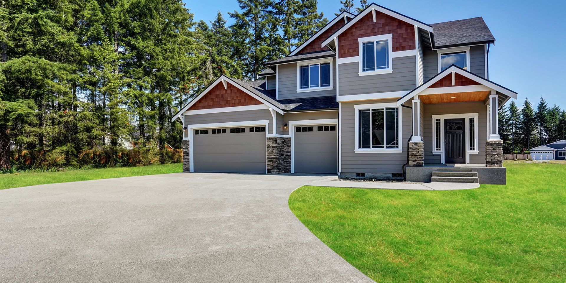 A large house with a large driveway in front of it.