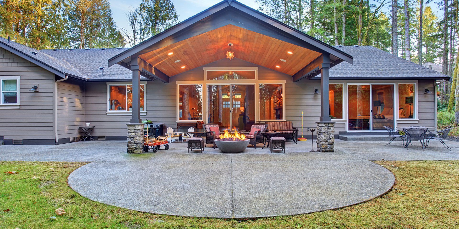 A large house with a fire pit in the backyard.