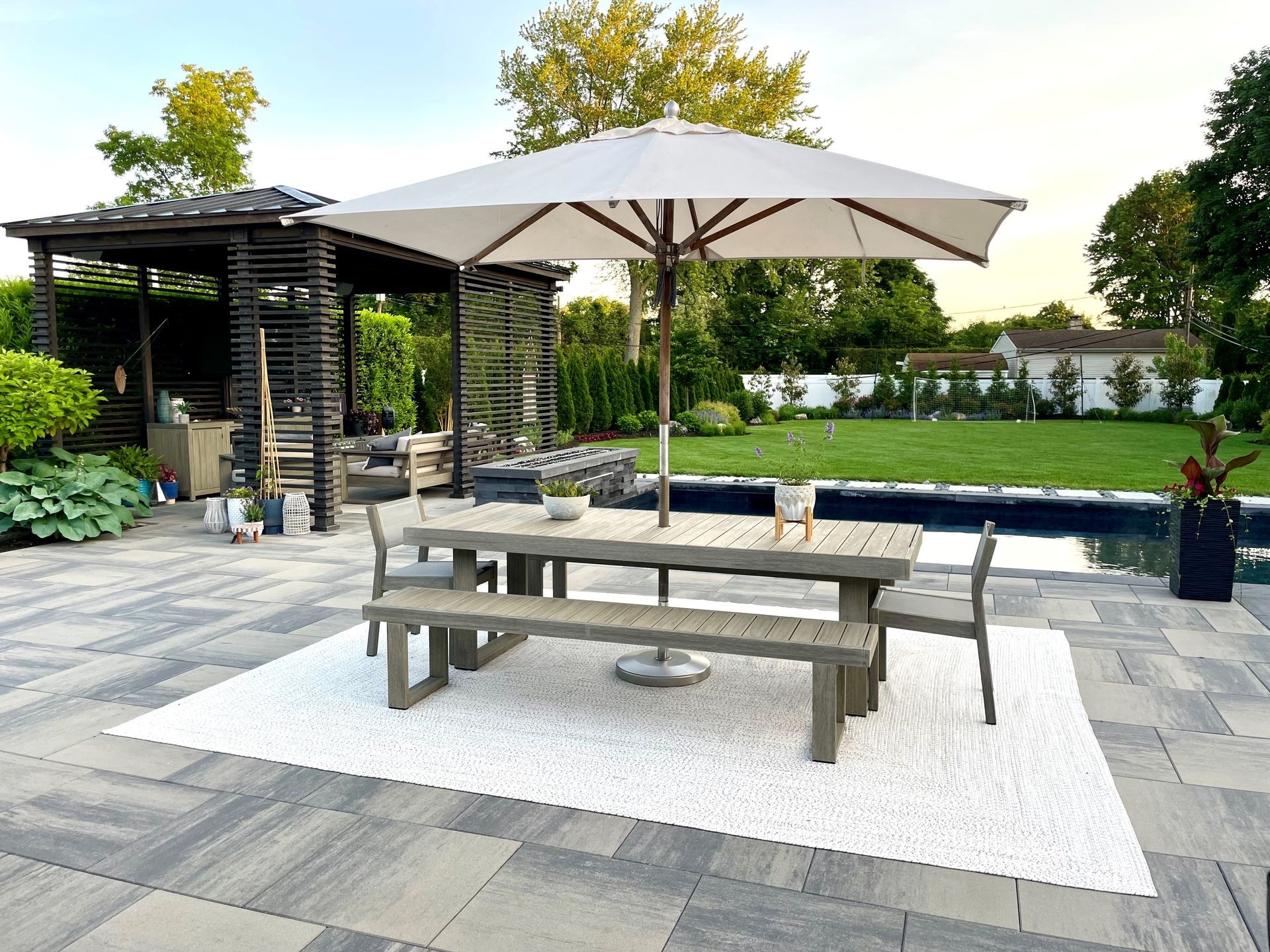 A patio with a table and chairs under an umbrella