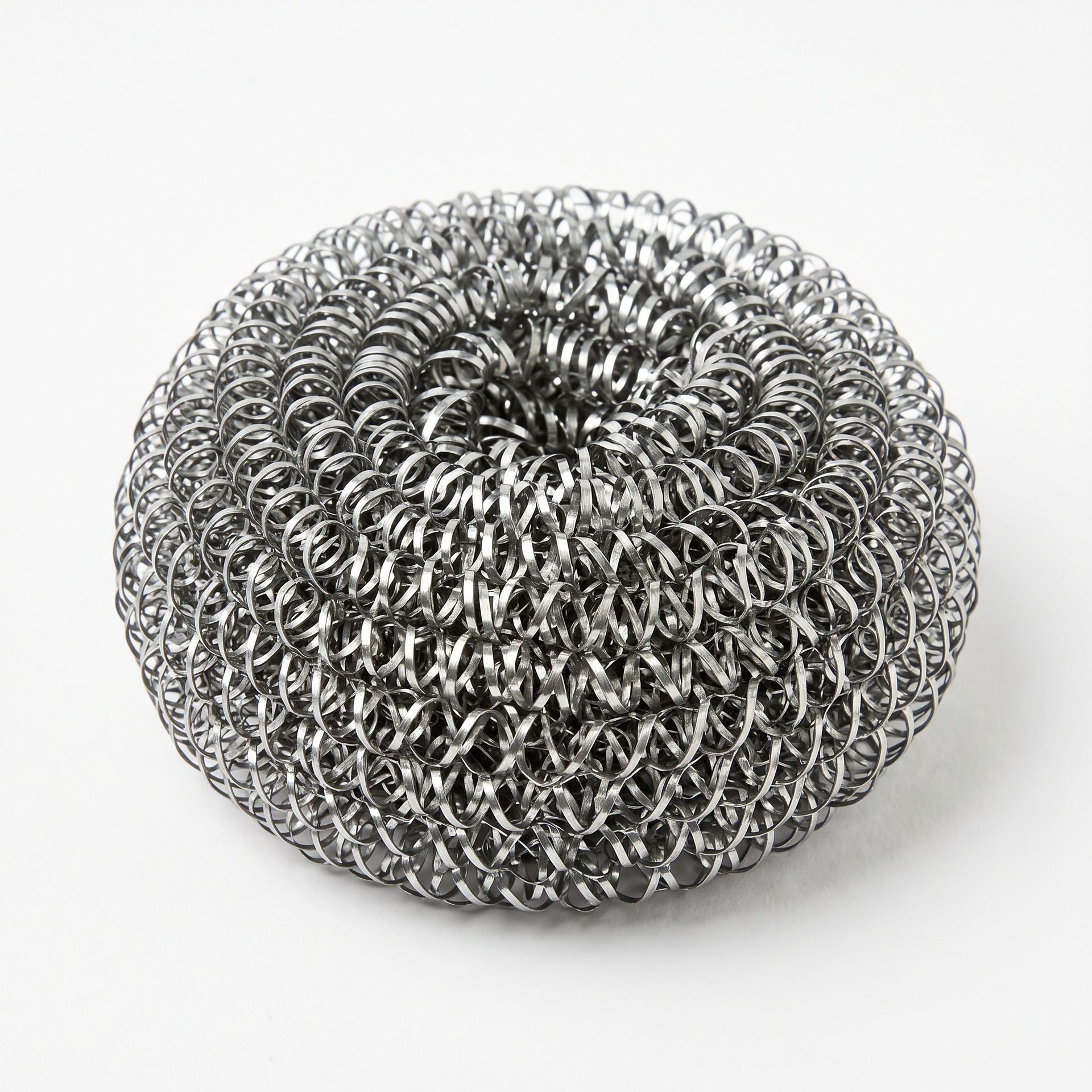Silver metal scrubber sponge on a white background
