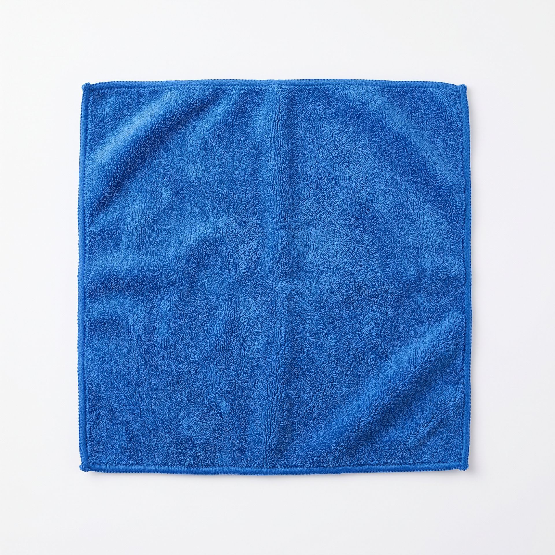 Blue microfiber cleaning cloth folded into a square on a white background