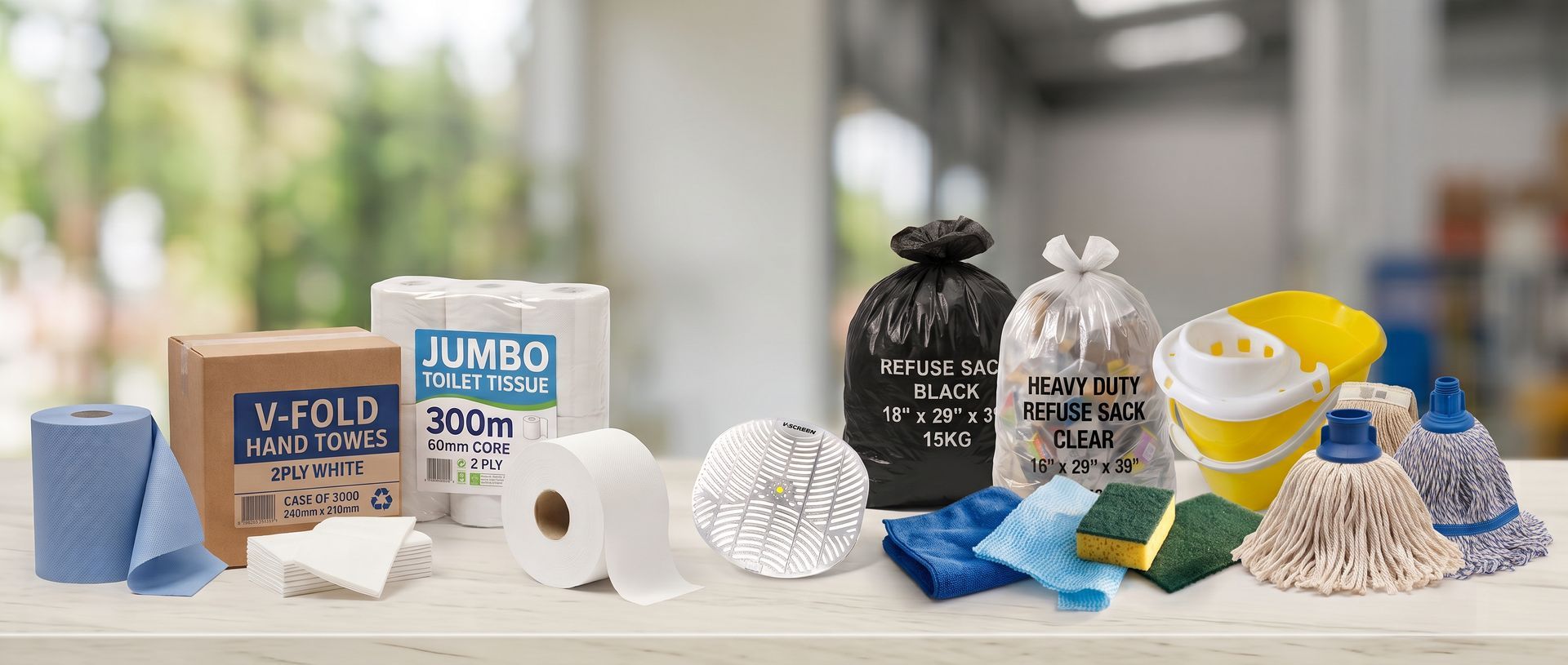 Assorted toilet paper and paper towel rolls on a countertop in a bright kitchen.