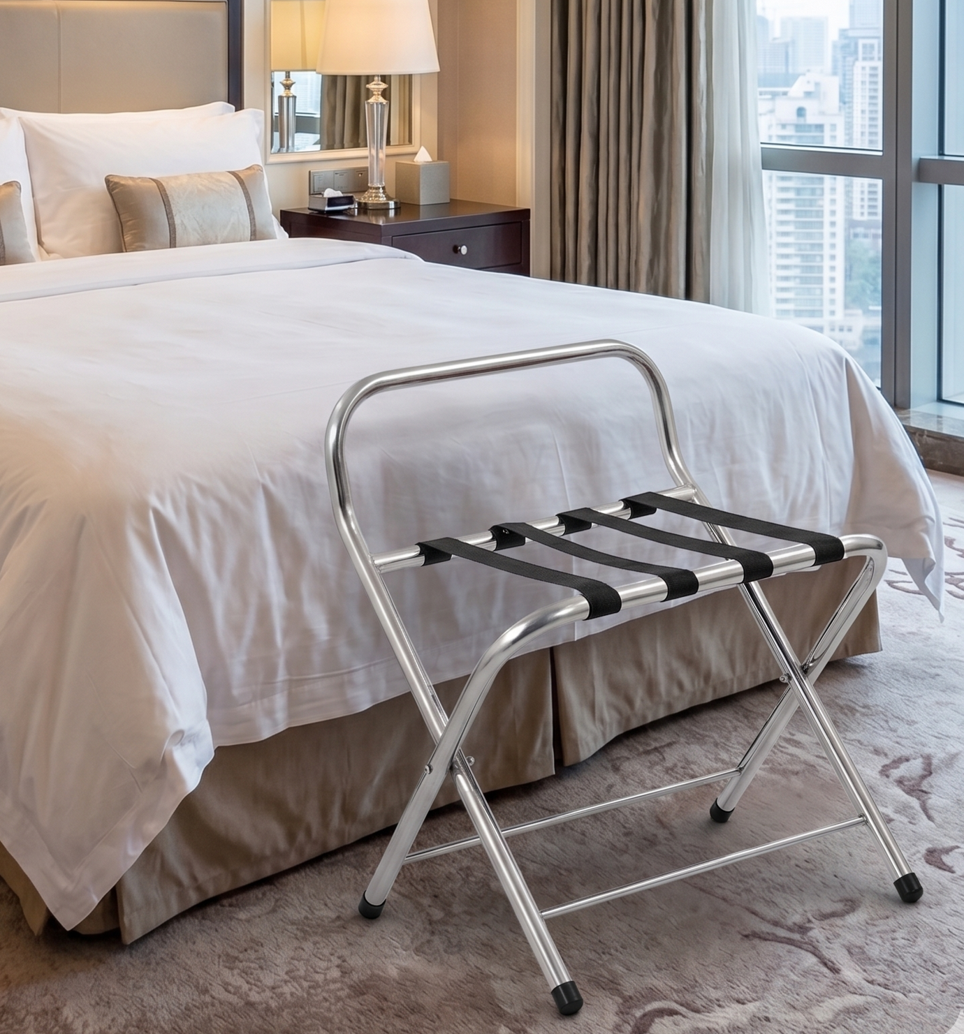 Hotel room with a bed, luggage rack, bedside lamp, and a city view through tall windows