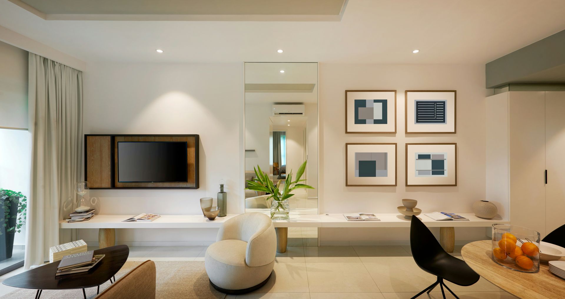 Living room with white walls, TV, artwork, modern furniture.