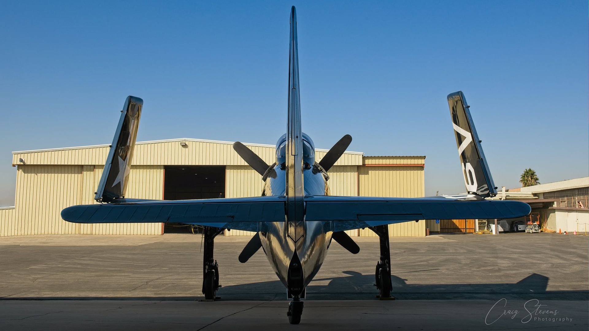 Rear View of a Blue Propeller Aircraft Parked on a Runway — Craig Stevens Photography in Sydney, NSW