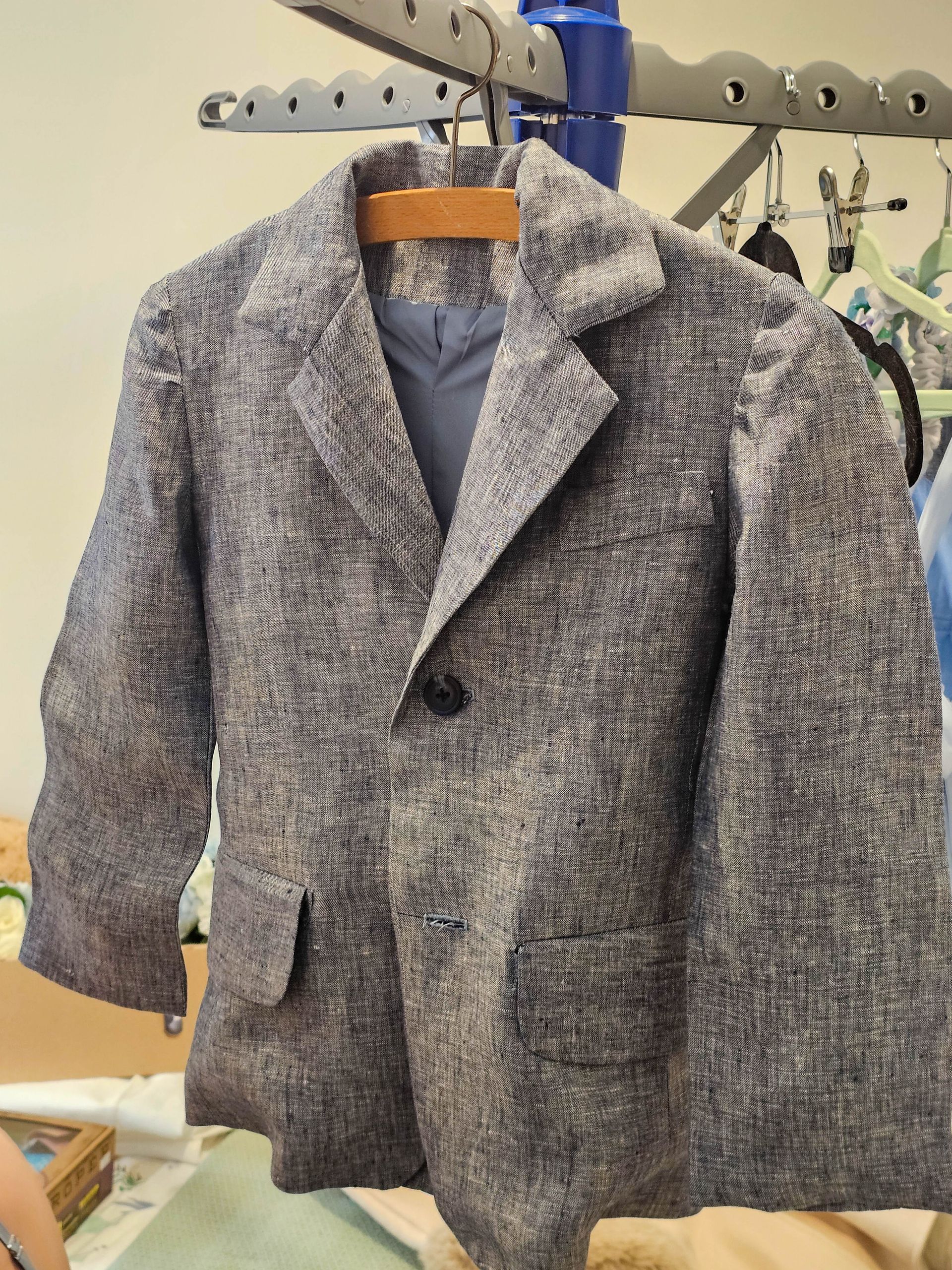 Gray Textured Blazer on A Hanger in A Clothing Rack, Displayed in A Store or Shop Setting — Craig Stevens Photography in Pearl Beach, NSW