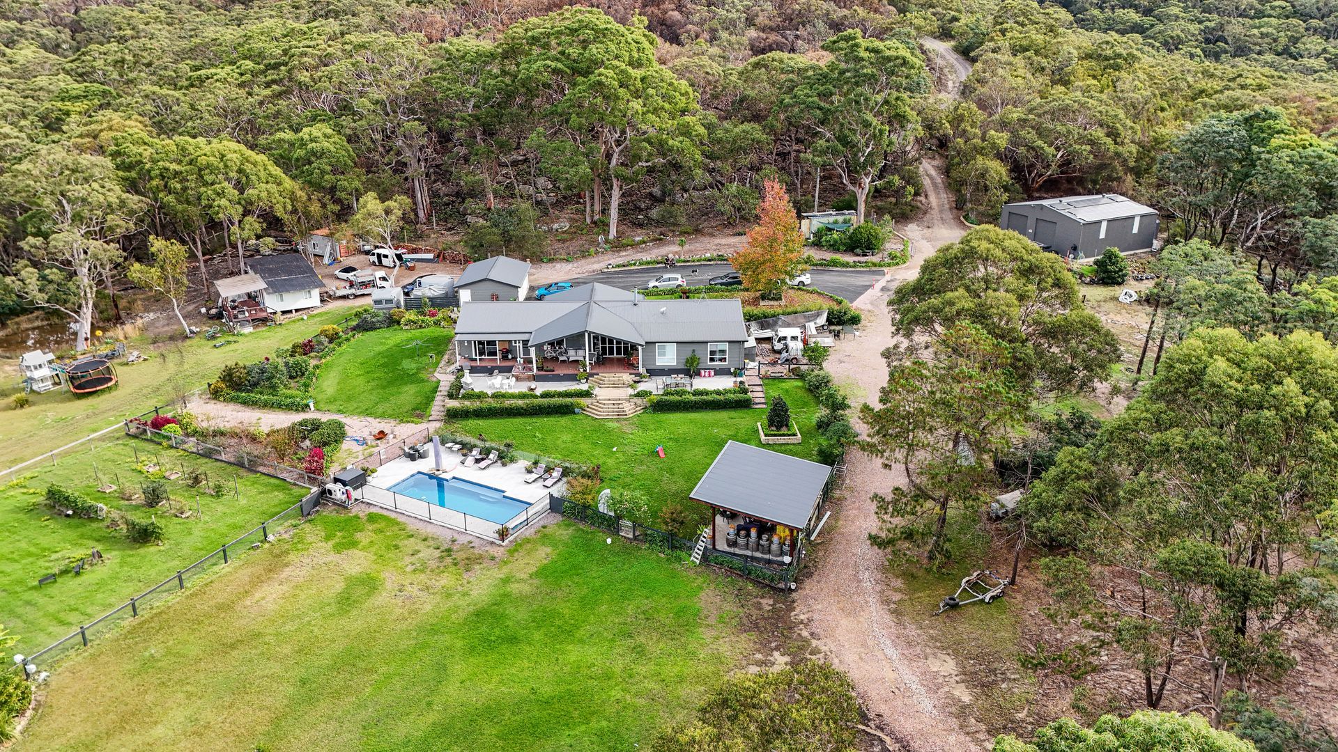 Aerial View Of A House With A Pool, Lawn Surrounded By Trees  — Craig Stevens Photography in Sydney, NSW