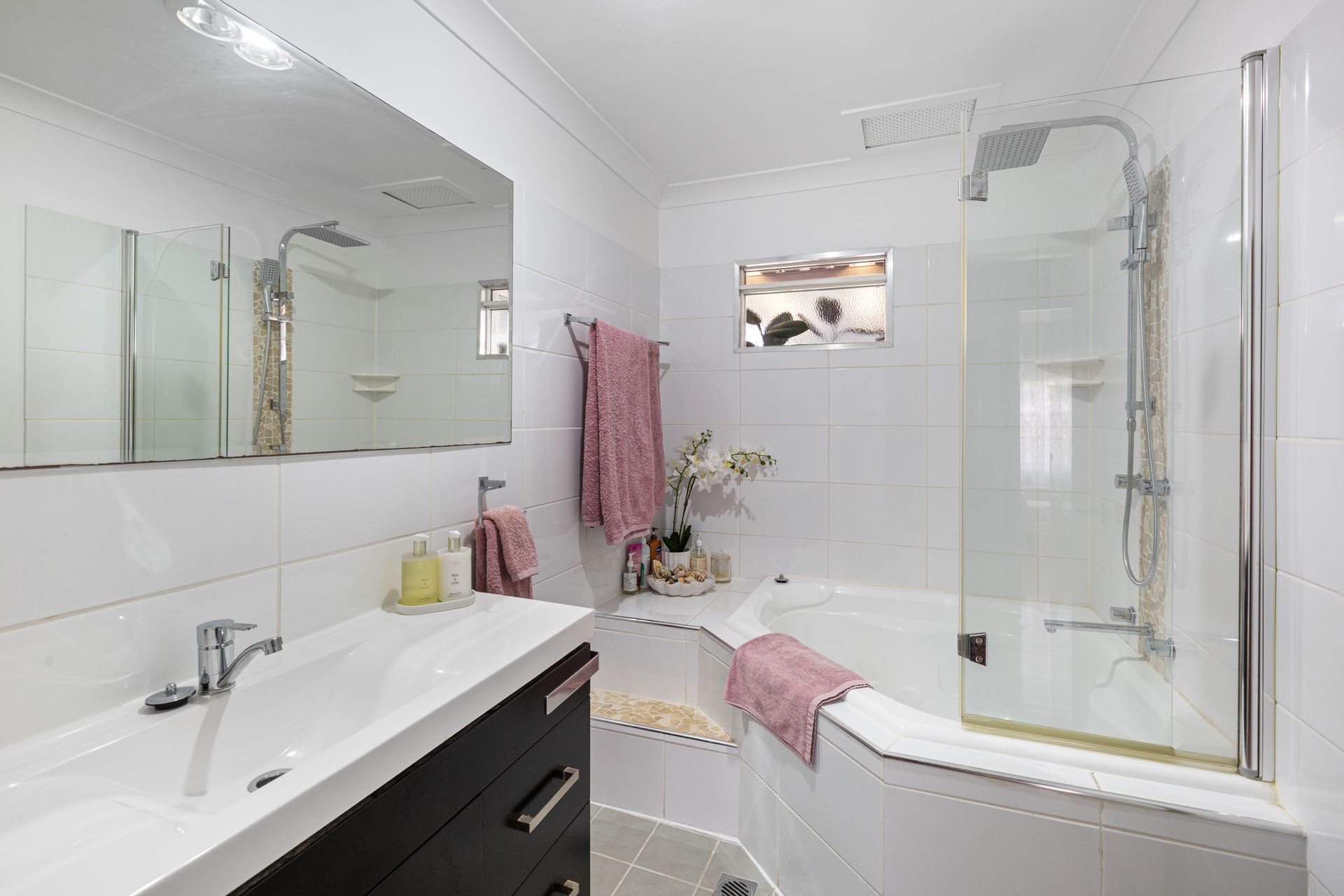 Bright White Bathroom With Double Vanity, Large Mirror, And Shower — Craig Stevens Photography in Sydney, NSW