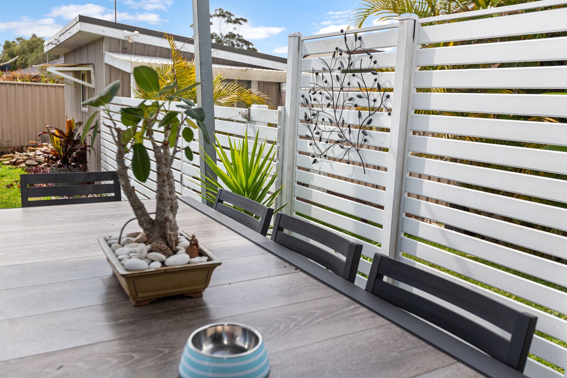 Patio With Wood Deck, Potted Plants, And White Slatted Fence — Craig Stevens Photography in Sydney, NSW