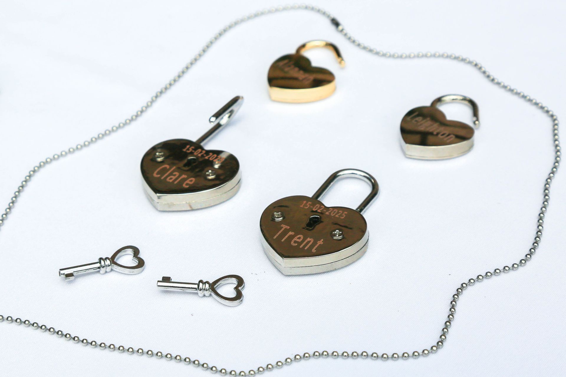 Heart Shaped Padlock Jewelry with Chain and Small Keys on A White Background — Craig Stevens Photography in Pearl Beach, NSW