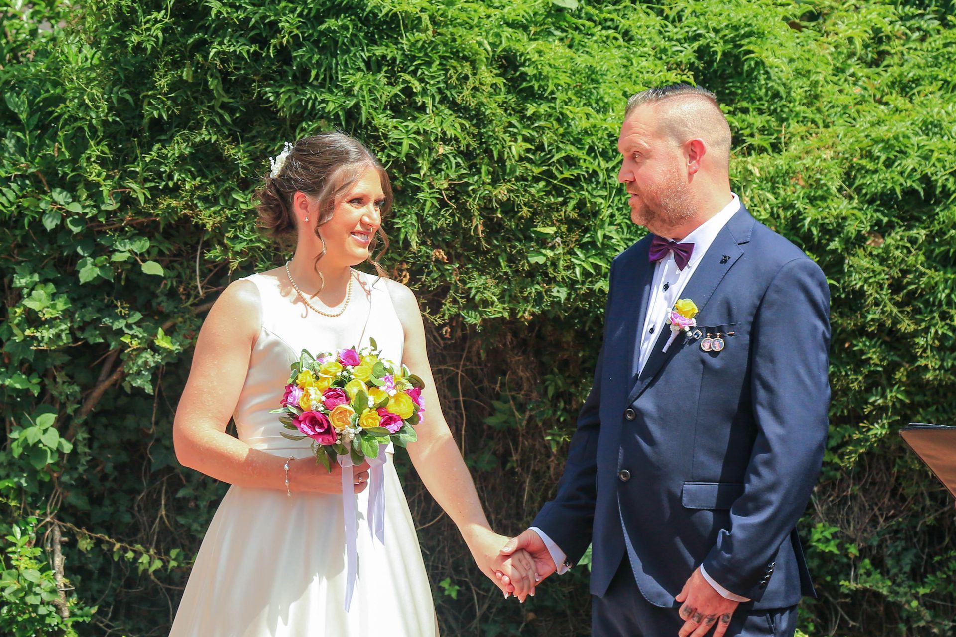 Bride And Groom Holding Hands In A Garden, Smiling — Craig Stevens Photography in Pearl Beach, NSW
